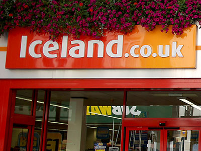 Iceland Store front .co.uk with flowers hanging 