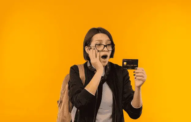 woman wondering at credit card